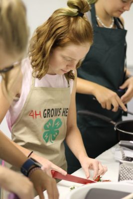 4-H youth practicing for a cooking challenge